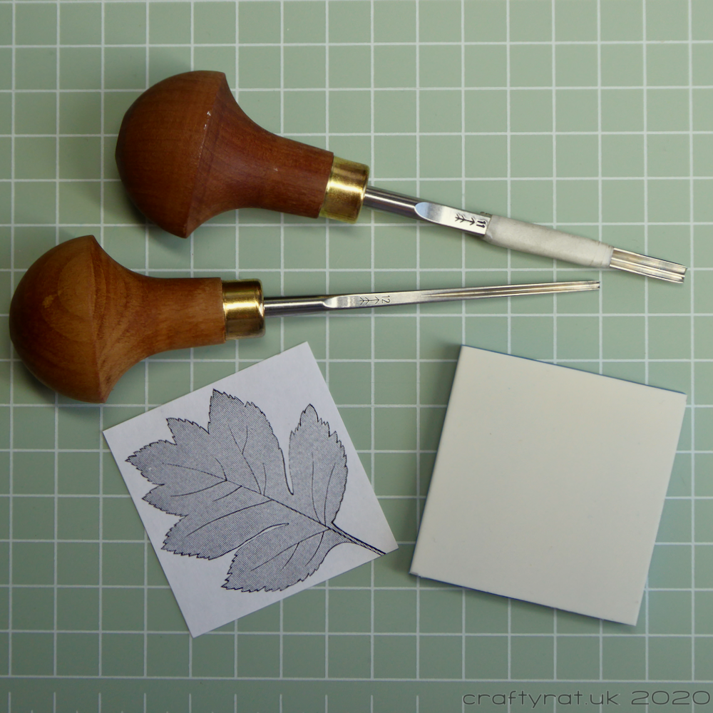 Two Pfeil linocut tools, a block of carving rubber and a printed leaf image.