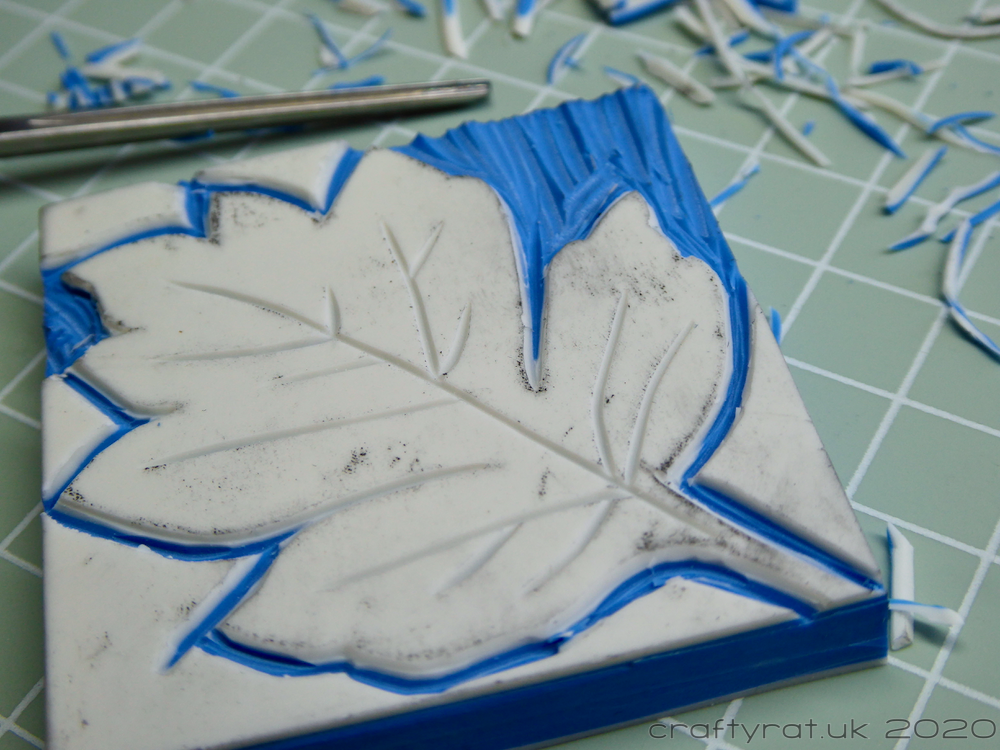 The leaf outline cut has been emphasised and the background has started to be cleared.