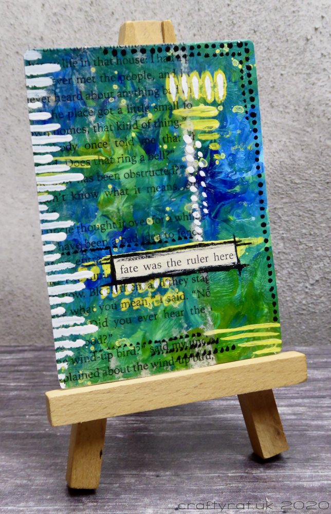 The art card displayed on a mini easel.