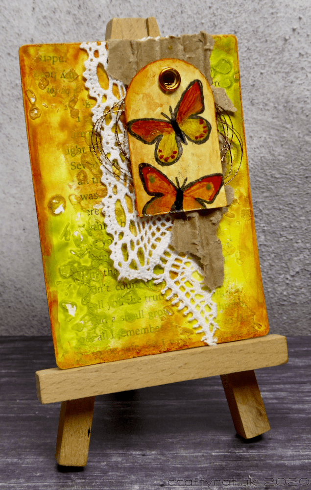 The art card displayed on a mini easel.