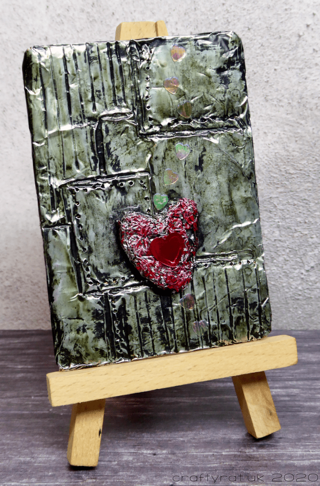 The art card displayed on a mini easel.