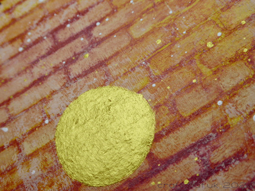 Close-up of the brick texture and a gold circle and splatter.