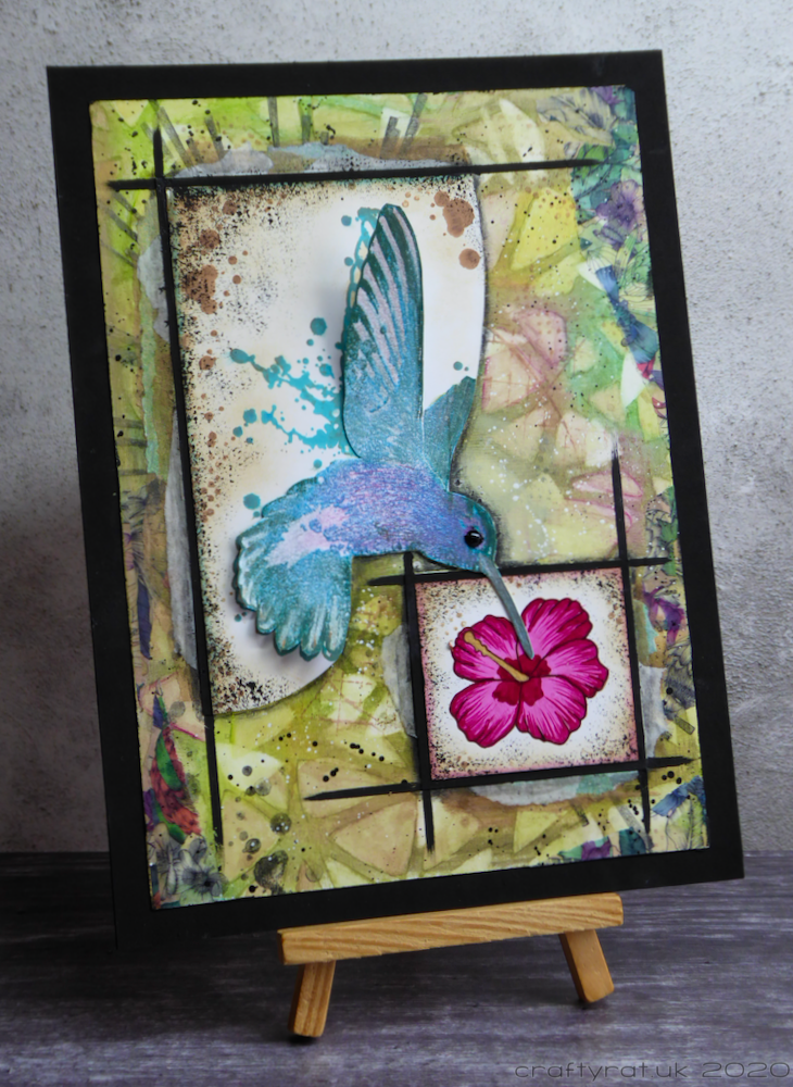 Hummingbird mixed media piece displayed on a mini easel.