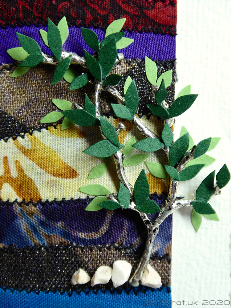 Close-up of the metal tree with individually cut card leaves.