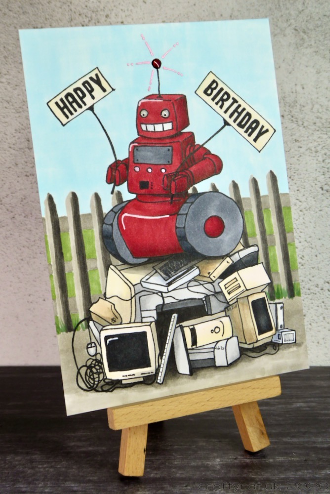 Junkyard robot birthday card displayed on a small wooden easel.