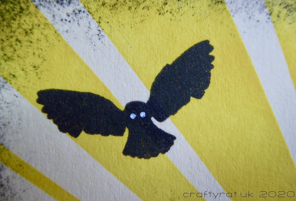 Close-up of the silhouetted owl in flight.