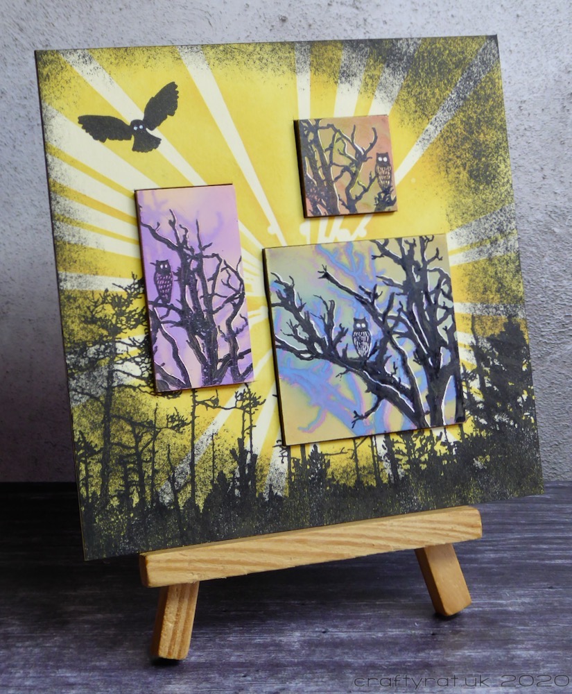 "Forest Owls" displayed on a small wooden easel.
