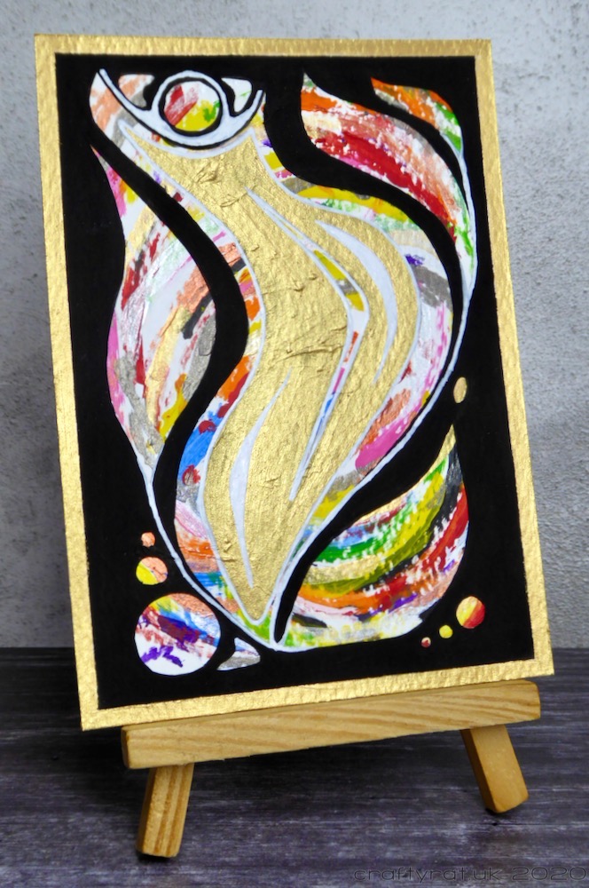 Abstract painting displayed on a mini wooden easel.