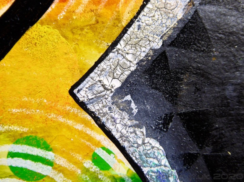 Close-up of the crackle paste edging on the yellow part of the infinity symbol.