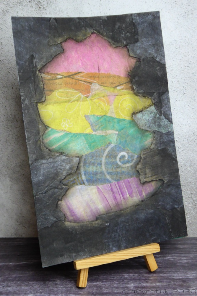 The matching collage page: black edging with a pastel paper rainbow area in the centre.