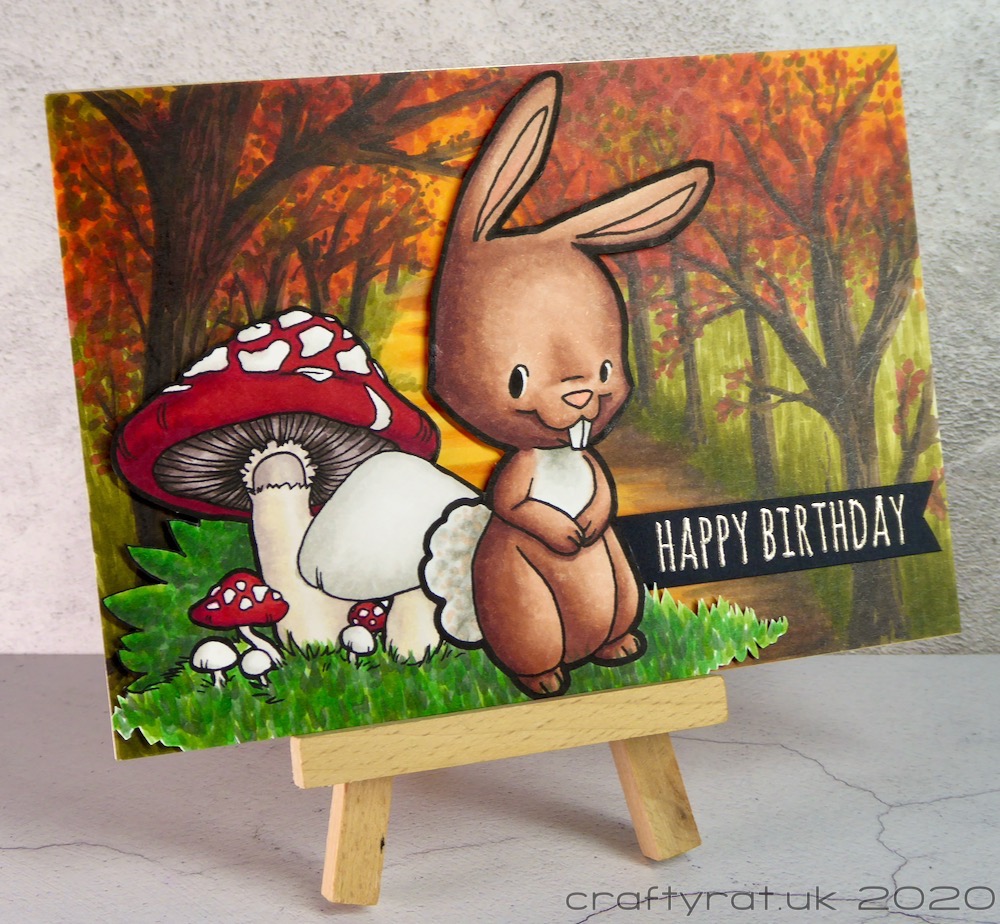 The birthday card displayed on a small wooden easel.