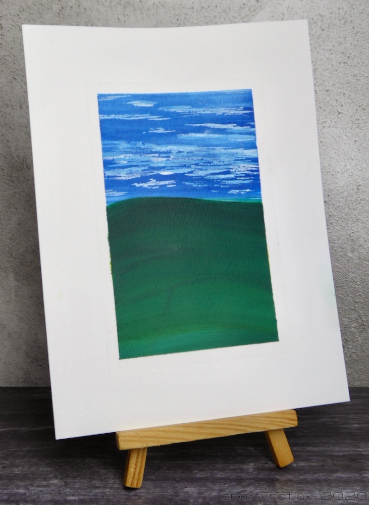 The landscape displayed on a small wooden easel.