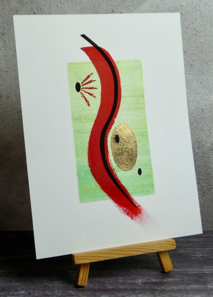 The painting displayed on a small wooden easel.