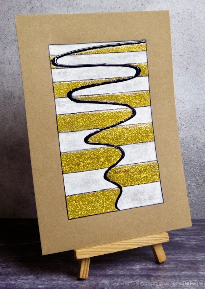 The abstract piece displayed on a small wooden easel.