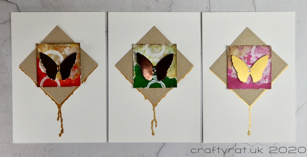 Three panels with orange, green and pink painted squares.