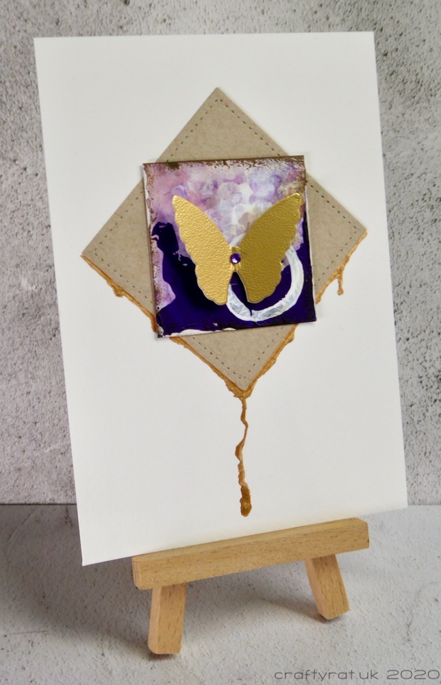 The butterfly panel displayed on a small wooden easel.