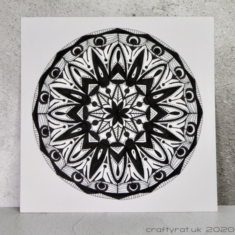 A black and white mandala drawing.