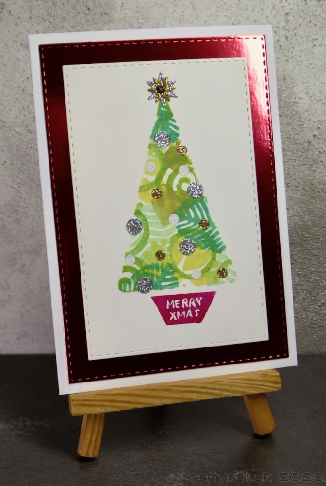 The Christmas tree card displayed on a small wooden easel.