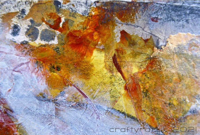 Close-up of part of the background showing the texture of the paint, collage and stencilling.