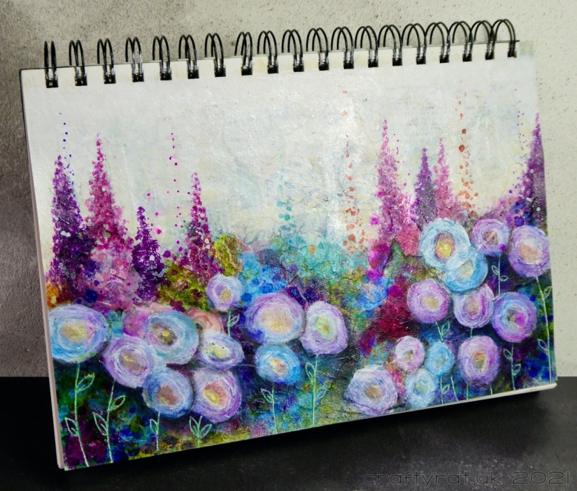 The flowery art journal page displayed at an angle.