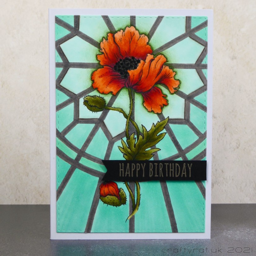 Birthday card with an orange poppy on a teal rose window background.