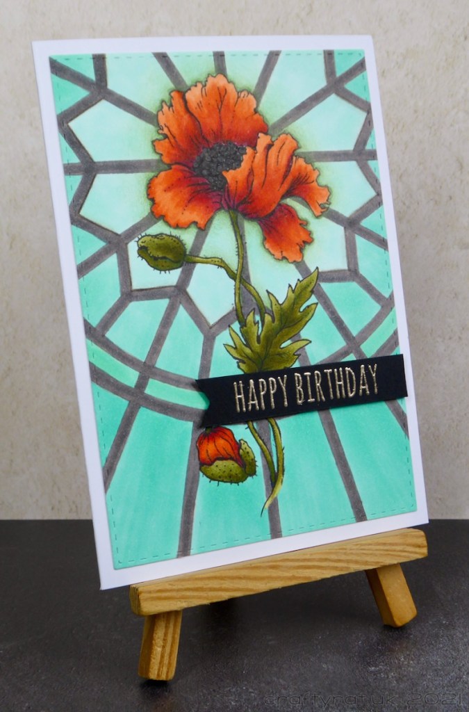 The birthday card displayed on a small wooden easel.