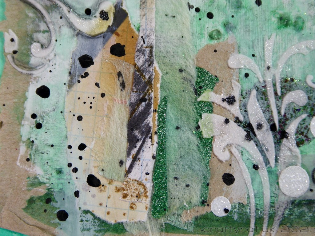A close-up of the collage and texture paste in the corner of the page.