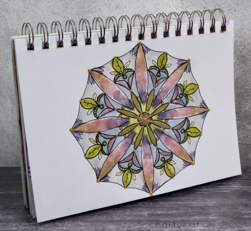The art journal with the mandala displayed at an angle.